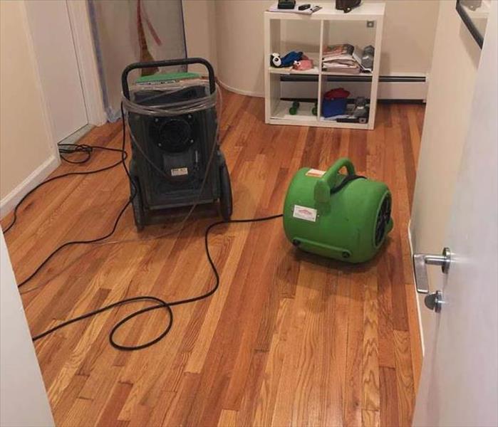 water damage hardwood floors with drying equipment