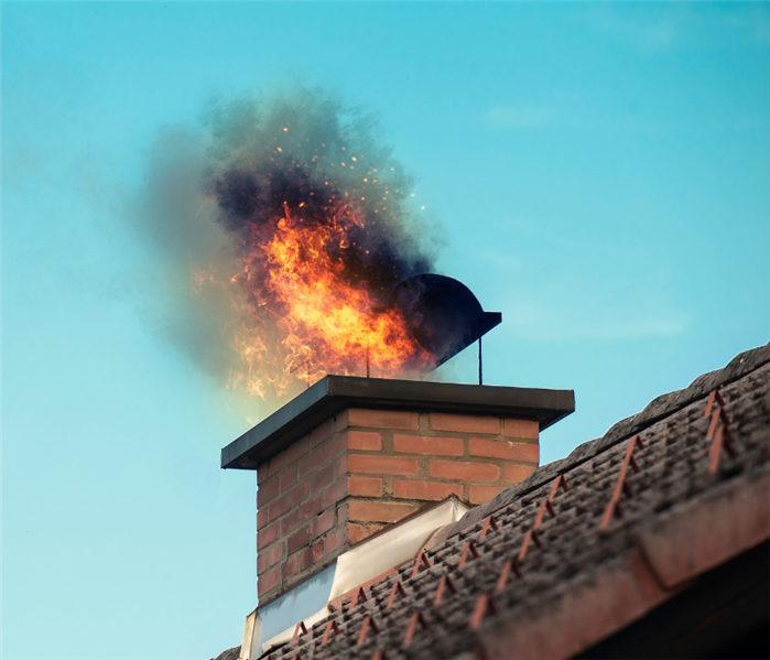 photo of flames coming out of chimney because of a chimney fire